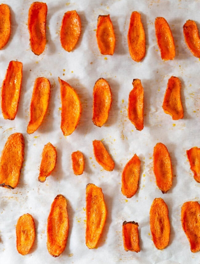 carrot chips Carrot chips lined up on a baking sheet after being baked.