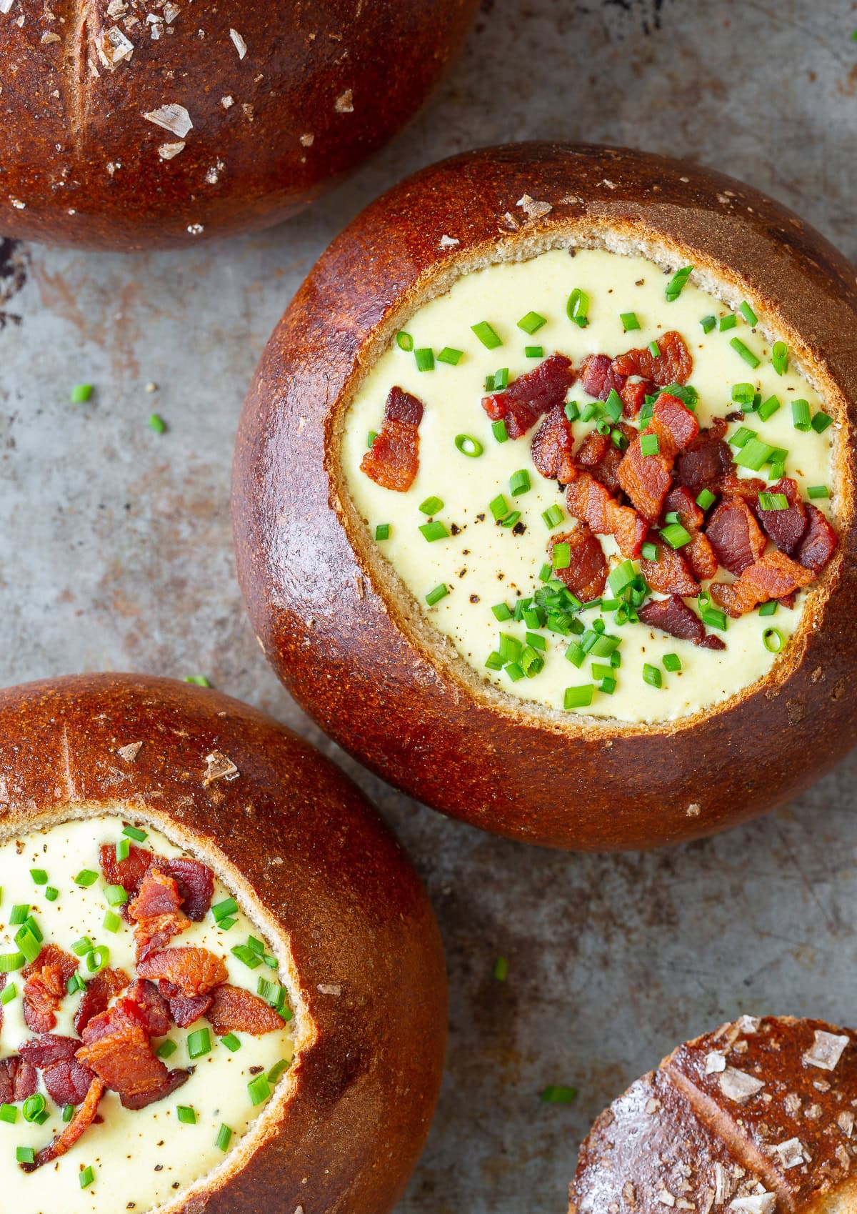 Overhead shot of bread bowls filled with soup.