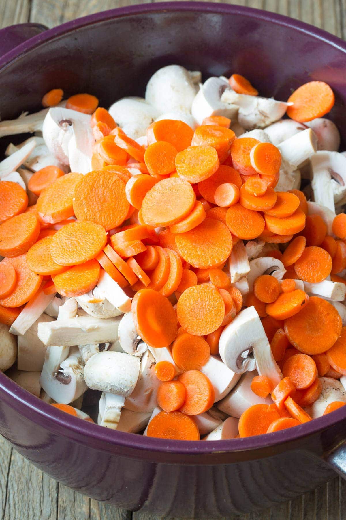 Carrots and Mushrooms #ASpicyPerspective #BeefStew #BeefStewRecipe #Stew #StewRecipe #Beef #Crockpot #InstantPot #Stovetop #BeefStewCrockpot #SlowCookerBeefStew #BestBeefStew #HowtoMakeBeefStew Carrots and mushrooms being added to the beef stew.
