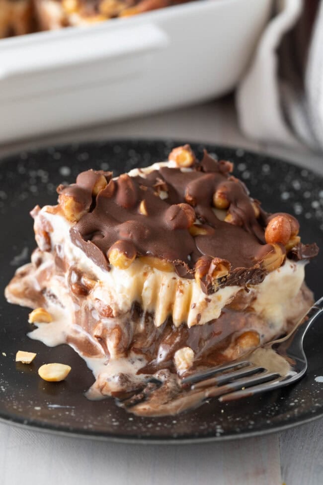 Buster bar ice cream cake copycat on a plate with a bite missing.