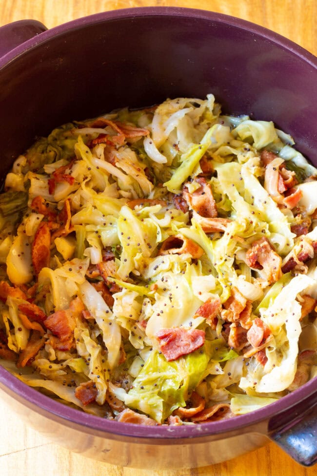 5-Ingredient Irish Cabbage and Bacon Recipe for Saint Patrick's Day! #ASpicyPerspective #IrishCabbageBacon #Irish #Cabbage #Bacon #StPatricksDay #Dinner #SideDish Irish bacon with cabbage cooked down in pot.