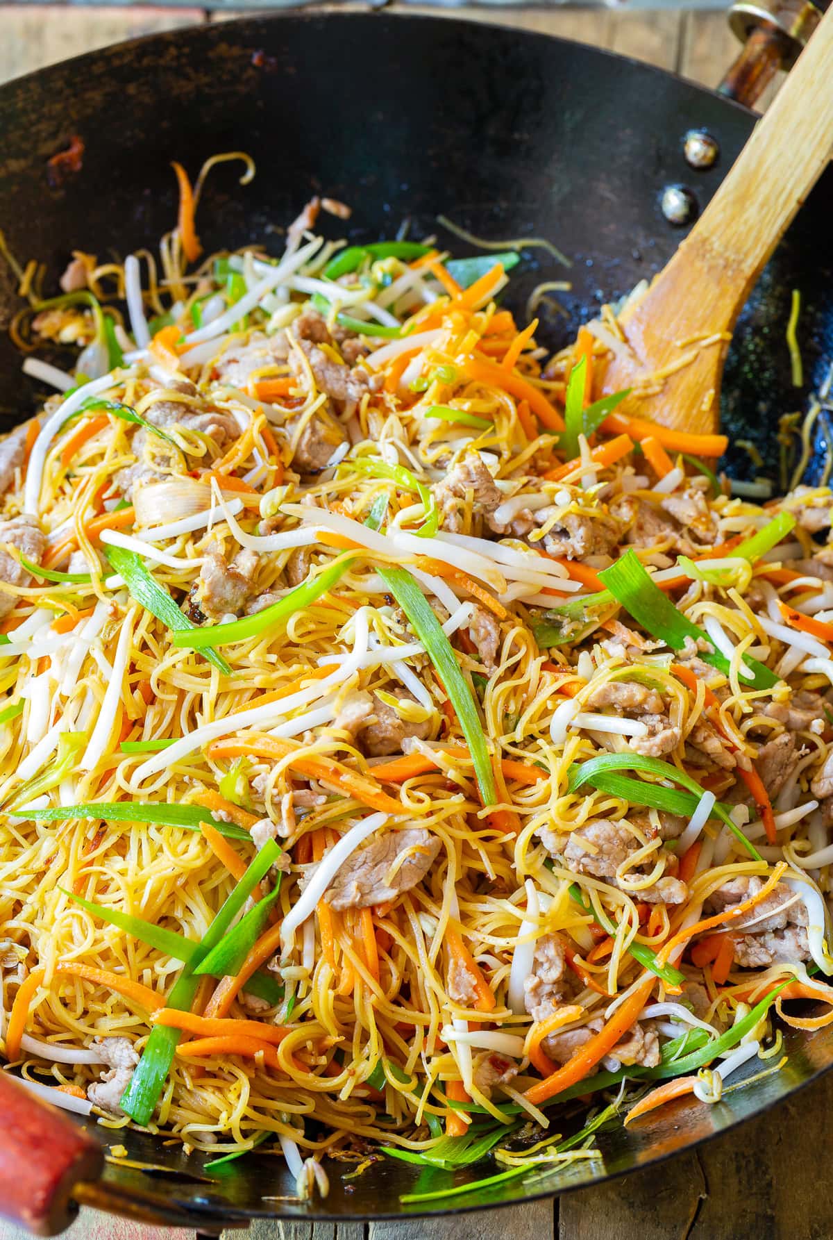 Pork lo mein (cantonese noodles) in a wok.