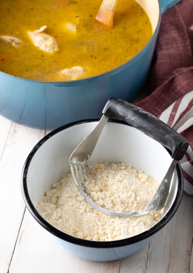 Mixing the dumpling dough with a pastry cutter.