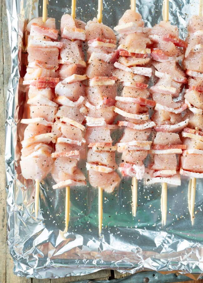 Kabobs #ASpicyPerspective #Chicken #Bacon #BBQ #Chipotle #Skewers #ChickenSkewers #BBQChicken #ChickenSkewersRecipe #BBQSkewers #ChipotleChicken #Grill #Summer Kabobs with chicken and bacon on foil ready for the grill
Chicken Skewers Recipe with Chipotle BBQ Sauce