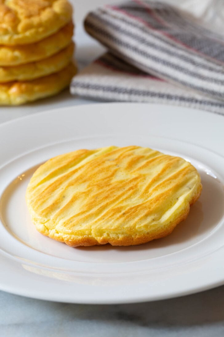 No Carb Bread #ASpicyPerspective #LowCarb #GlutenFree #GrainFree #Keto #CloudBread #CloudBreadRecipe #KetoCloudBread #NoCarbBread Piece of cloud bread on a large white plate.