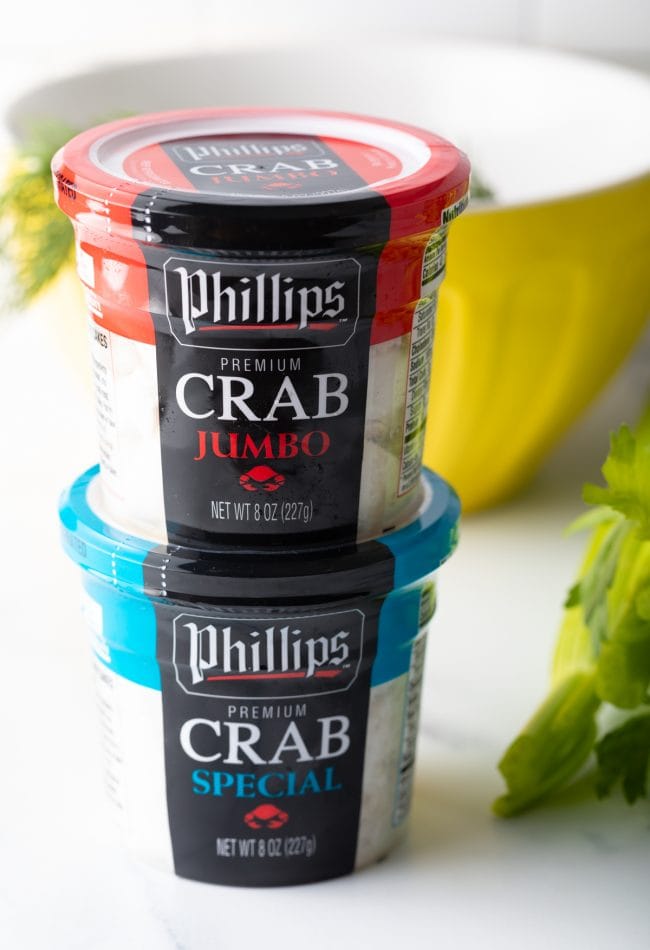 Two containers of crab meat stacked on top of each other.