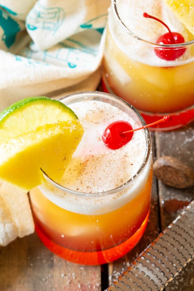 Top view of this fruity Drunken Monkey Rum Drinks with a layer of foam and a maraschino cherry