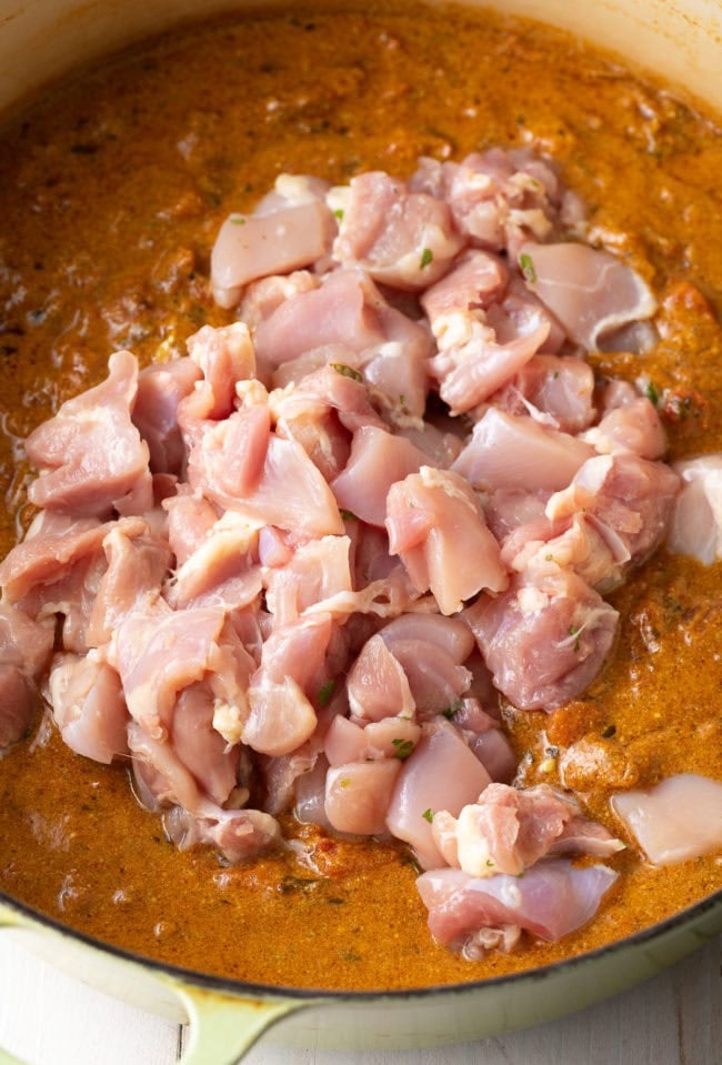 Easy Chicken Curry Recipe - Raw chicken to be simmered in the madras curry in a dutch oven.