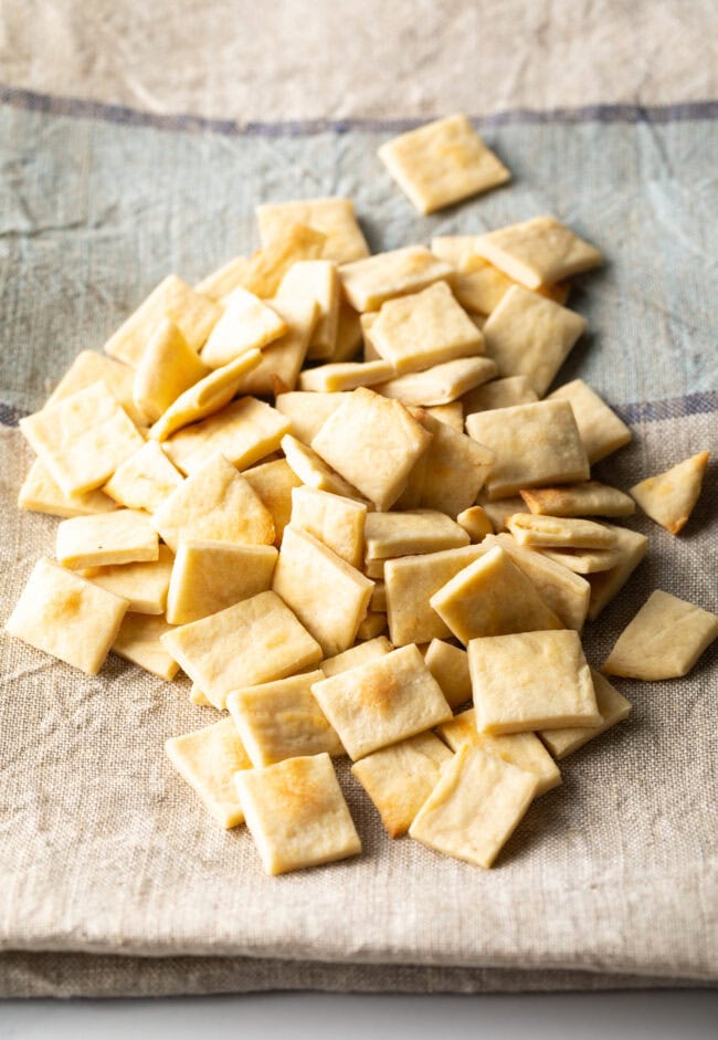 Pile of communion bread cut into small squares.
