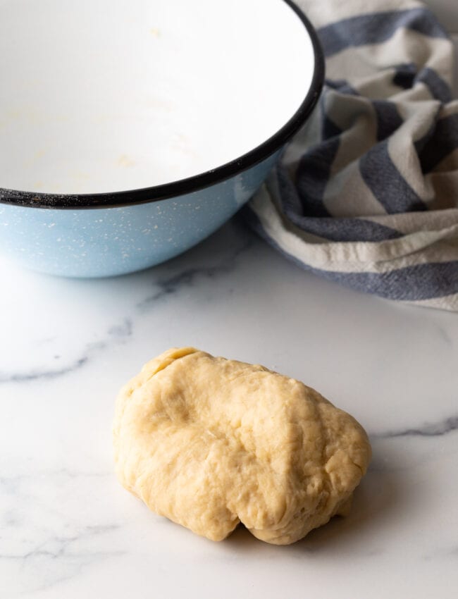 Ball of dough on a marble counter.