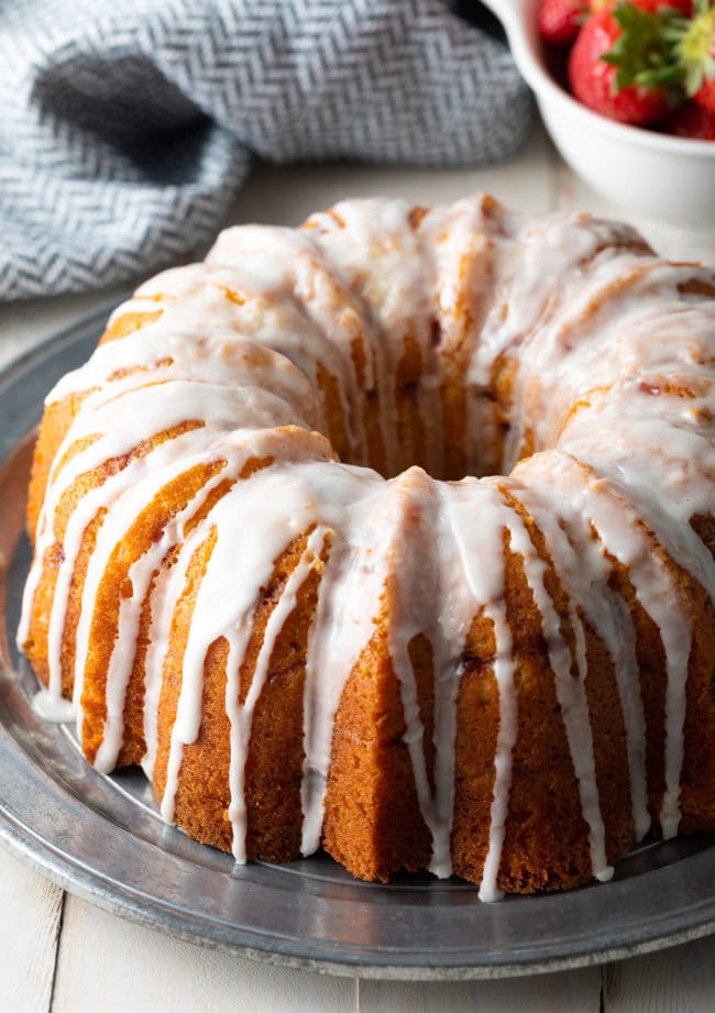 Cake with Fresh Strawberries served on a serving plate.