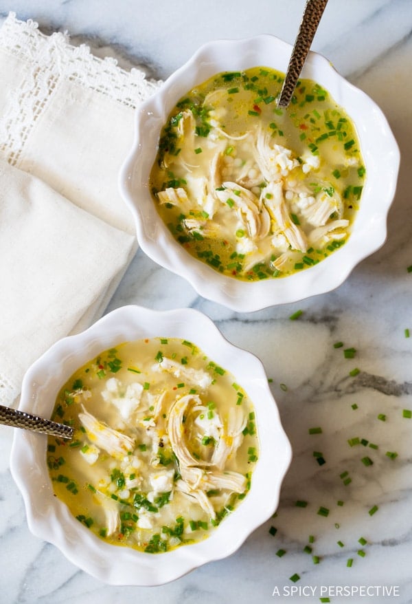 Greek Lemon Chicken Soup #ASpicyPerspective Overhead shot of two bowls of Greek lemon chicken soup.