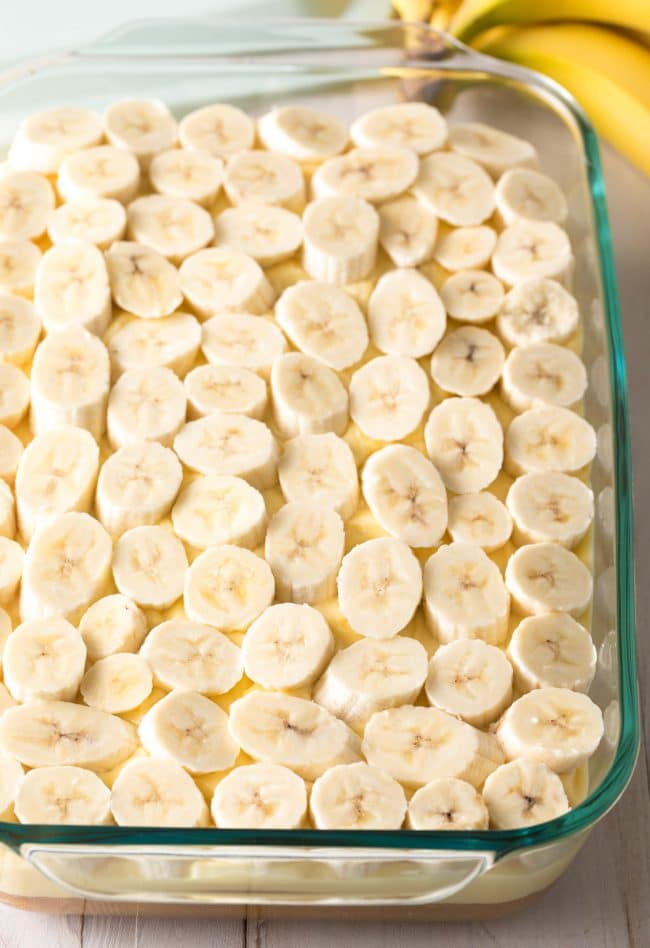Fresh banana slices on top of the pudding layer in the banana pudding cake.