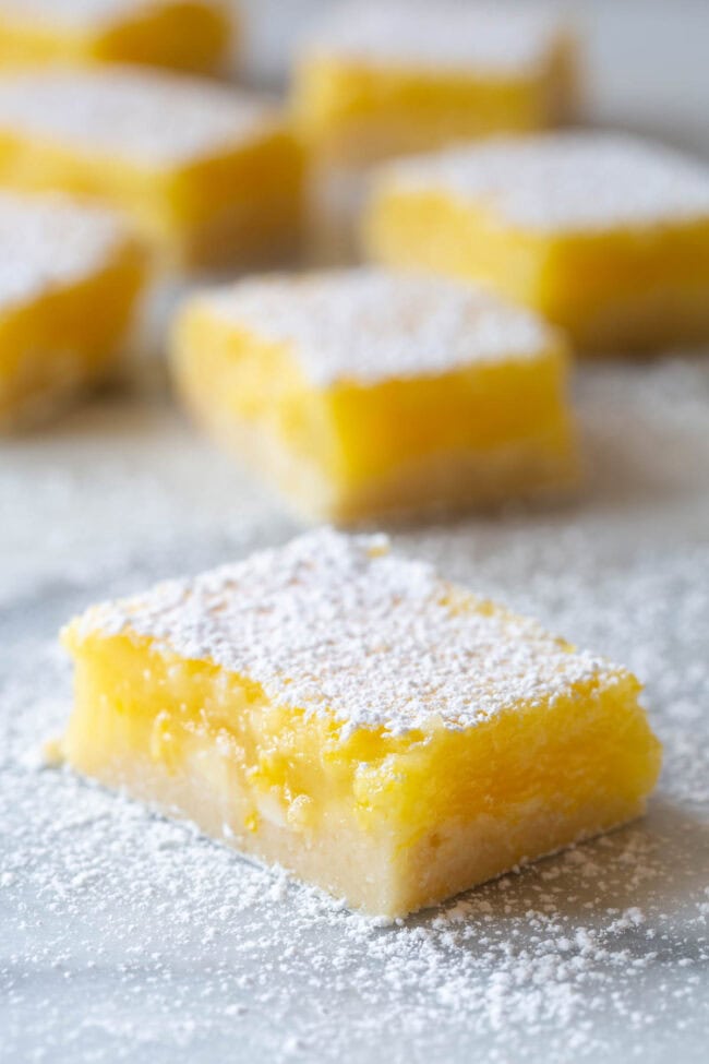 Lemon Squares #ASpicyPerspective #Lemon #Bars #LemonBars #LemonSquares #CookieCrust #WhiteChocolate #Spring #Dessert #Easter Lemon Squares Recipe - cut into lemon bars of squares