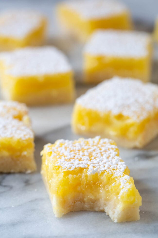 Lemon Bar Recipe #ASpicyPerspective #Lemon #Bars #LemonBars #LemonSquares #CookieCrust #WhiteChocolate #Spring #Dessert #Easter Best Lemon Bar Recipe - bite taken out