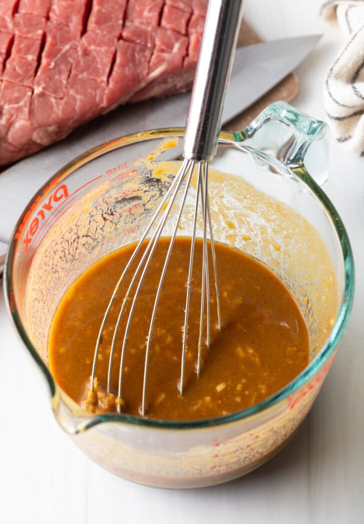 Whisk in a glass measuring cup with marinade.
