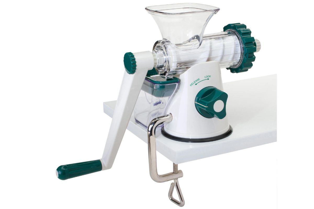 Manual juicer attached to a table.