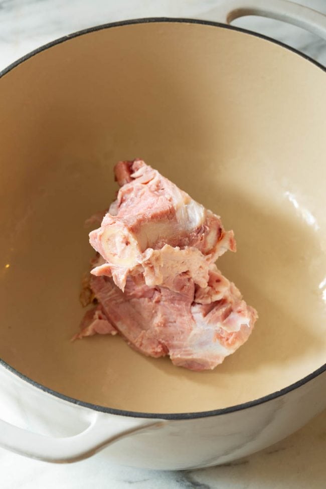 Ham Bone Soup #ASpicyPerspective #HamAndBeanSoup #NavyBeans #HamAndBeans #NavyBeanSoup #BeanSoup #Soup Dutch oven with a leftover bone for this ham bone soup