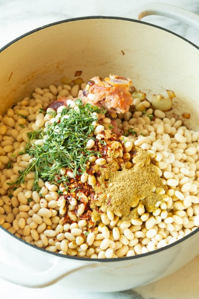 Bean Soup #ASpicyPerspective #HamAndBeanSoup #NavyBeans #HamAndBeans #NavyBeanSoup #BeanSoup #Soup Added beans, spices and herbs to the dutch oven pot