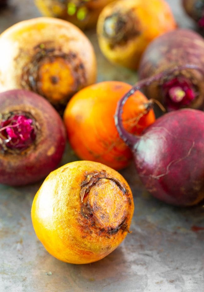 A few different types of beets on a metal surface.
