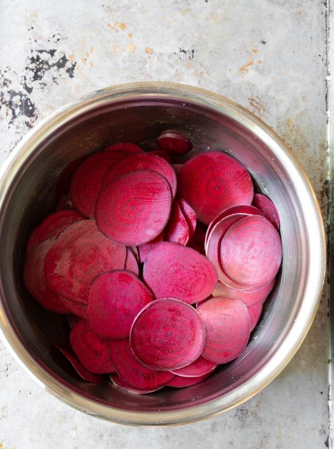 The beetroot โsweatingโ in salt and oil in a metal bowl to release moisture.