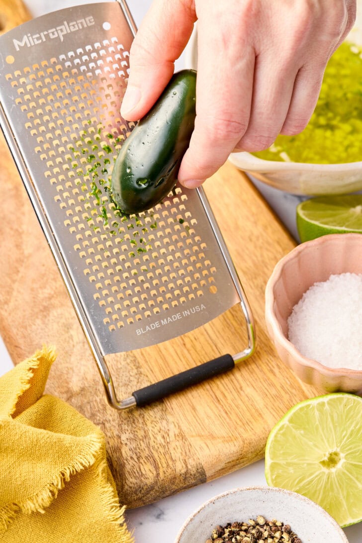 Seasoning Fish #ASpicyPerspective #Salmon #BakedSalmon #OvenBakedSalmon #SalmonInTheOven #HowLongtoBakeSalmon #Garlic #Lime #Jalapeno #SpicySalmon #Dinner #Fish Grating jalapenos for oven salmon recipe.