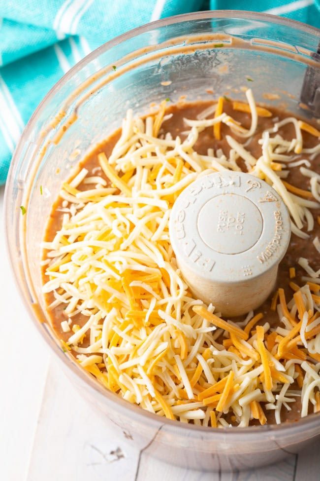 Mexican shredded cheese in the food processor with the beans.