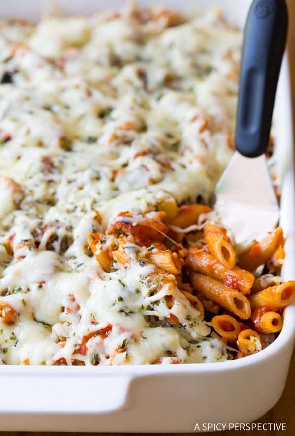 Supreme Pizza Baked Ziti Recipe in a baking dish with a spatula.
