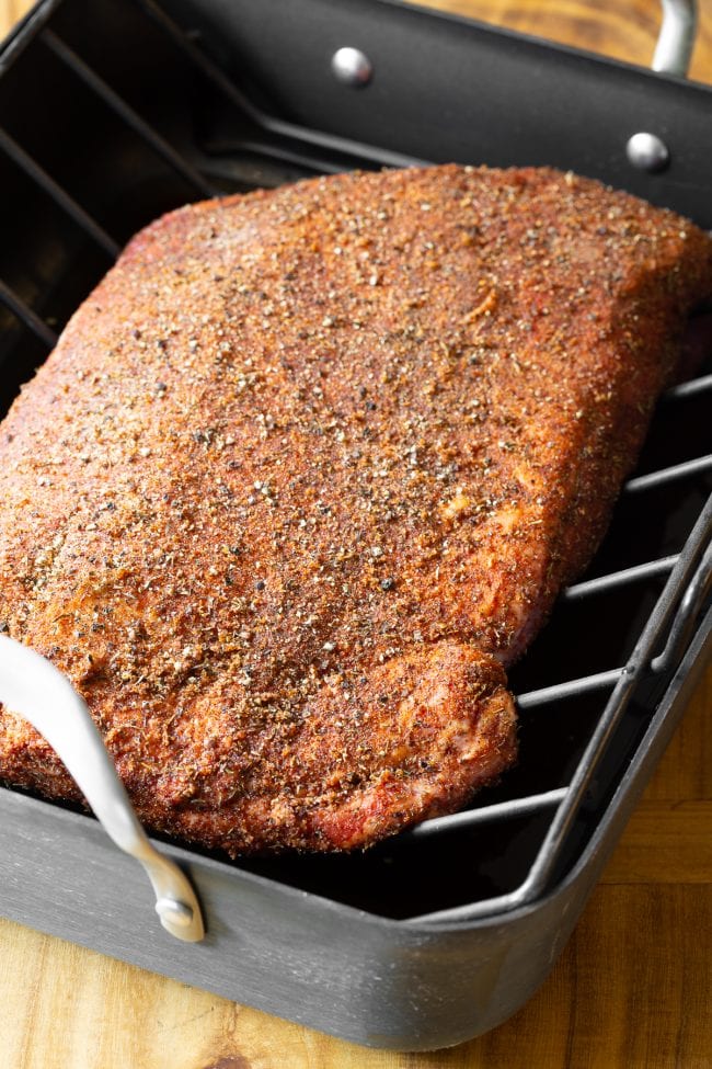 Beef Brisket Recipe #ASpicyPerspective #Brisket #BeefBrisket #BrisketRecipe #BeefBrisketRecipe #BrisektInOven #HowtoCookBrisket #TexasStyleBrisket #LiquidSmoke #SmokedBrisketRecipe #BrisketRecipeOven Oven beef brisket on a roasting pan with a rack.