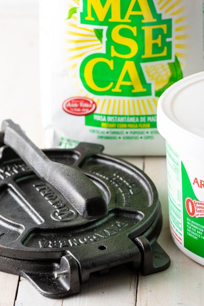 Victoria cast iron presser with a bag of maseca in the background.