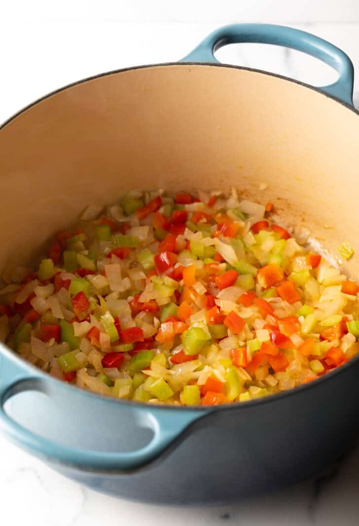 Cooking pot with chopped fresh peppers, onions, clelery, and garlic.